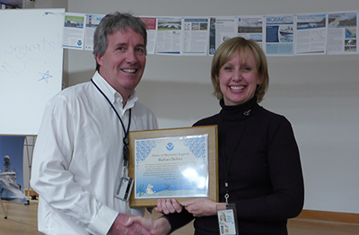 PSL Director Robert Webb presents a NOAA Silver Sherman Award to Barb DeLuisi